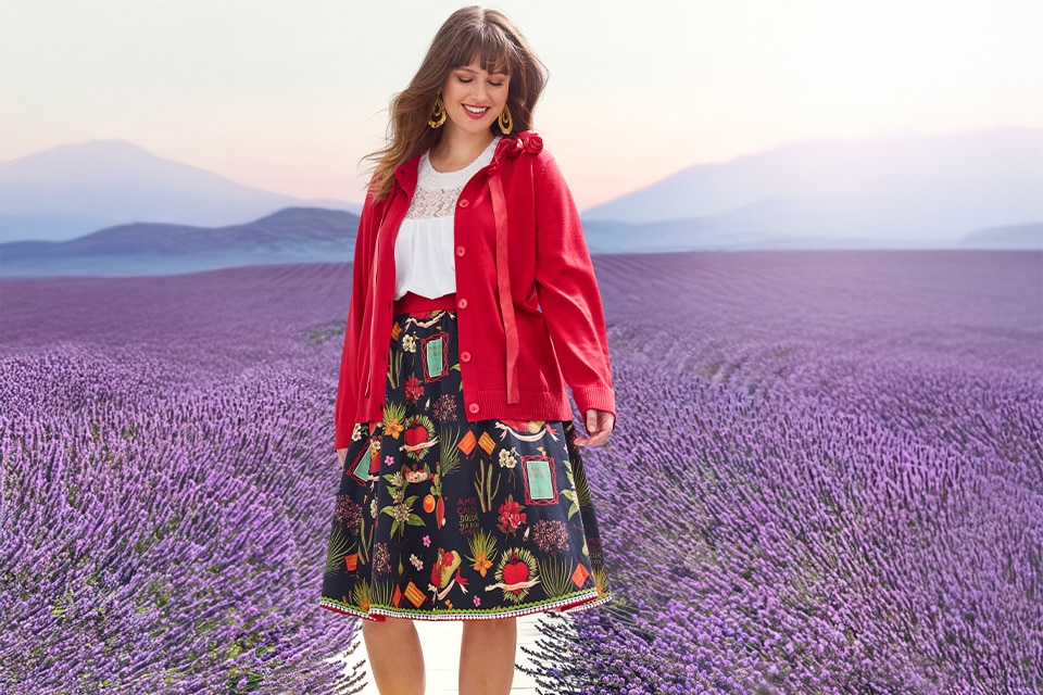The model wears a floral skirt and a red jacket