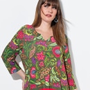 The model is wearing a colorfull blouse