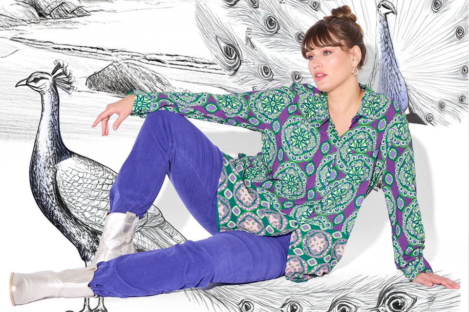 The model wears a blouse with pattern