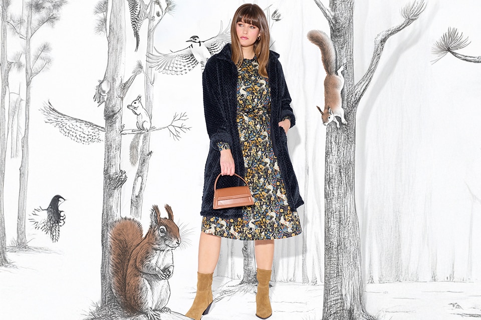 The model wears a colorful dress