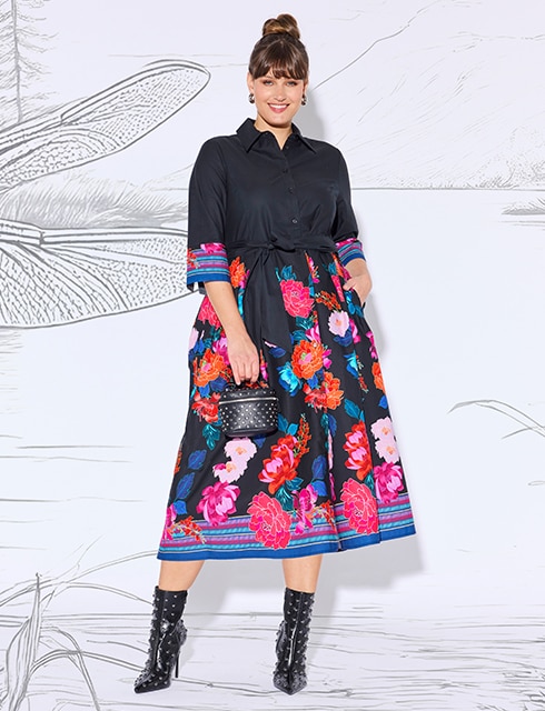 The model is wearing a colorful dress