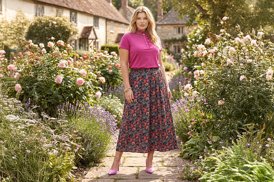 The model wears a colorful skirt