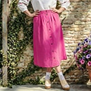 The model is wearing a pink skirt