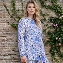 The model is wearing a blue and white blouse