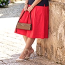 The model is wearing a red skirt.