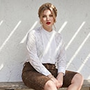 The model is wearing a white lace blouse
