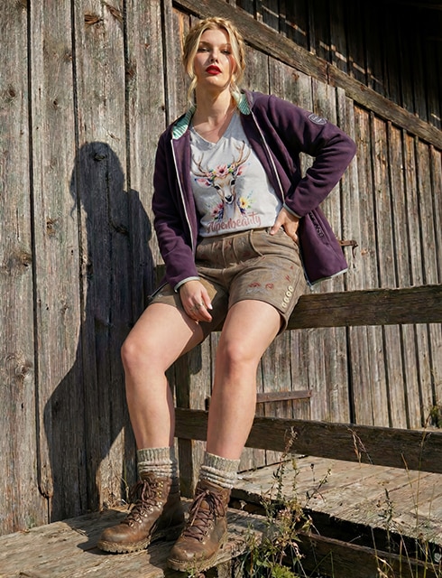 The model is wearing leather pants, a shirt and a jacket.