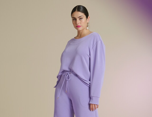 Studio shot of standing model in purple outfit