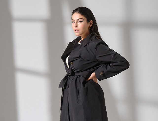Studio shot of model in black coat