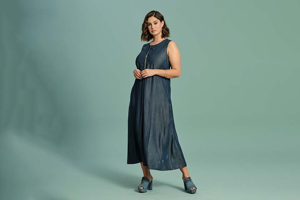 Model poses in denim dress