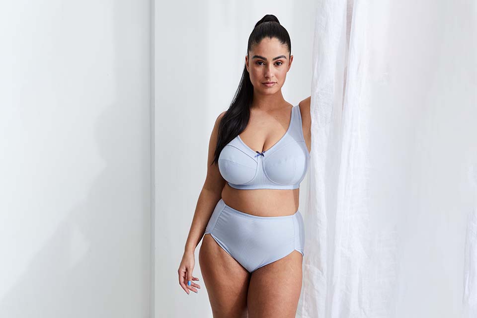 The model waers a light blue bra and slip