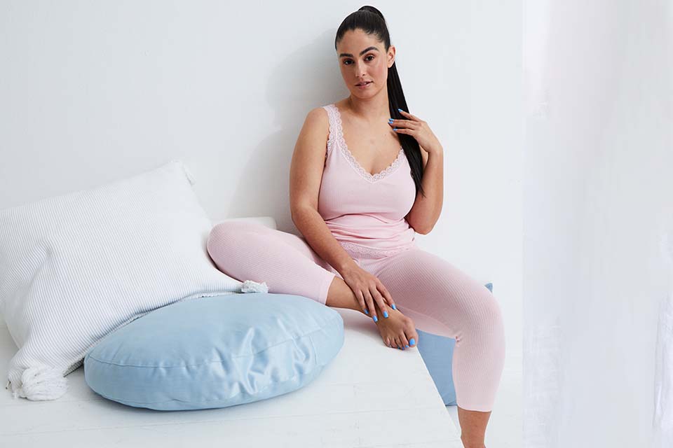 Model wears light pink pyjamas
