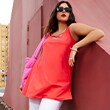 The model wears a red top