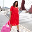 The model wears a red dress