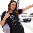 The model wears a black shirt