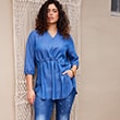 The model is wearing a light blue blouse