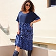 The model wears a blue dress