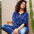 The model wears a blue shirt
