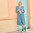 The model wears a dress with pattern