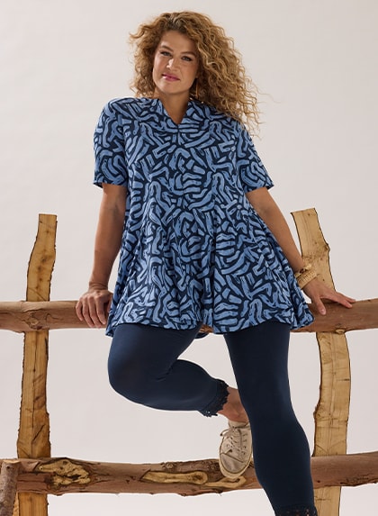 The model wears a blue shirt and jeans